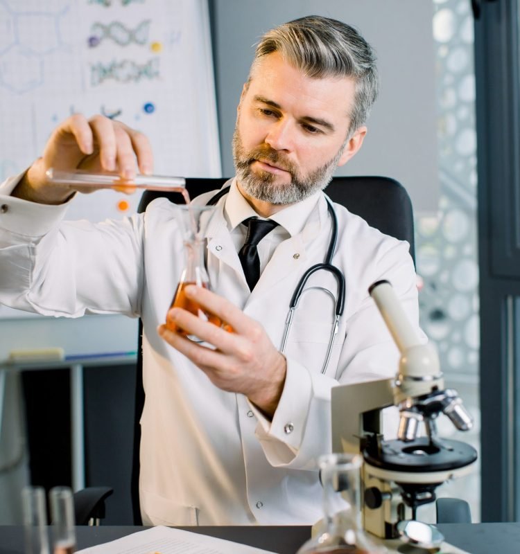 caucasian-man-virologist-bio-chemist-scientist-wearing-white-coat-holding-test-tube-and-dropped caucasian-man-virologist-bio-chemist-scientist-wearing-white-coat-holding-test-tube-and-dropped
